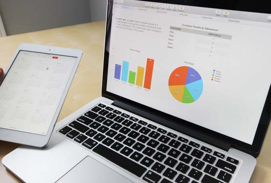 laptop and tablet view of charts and calendar