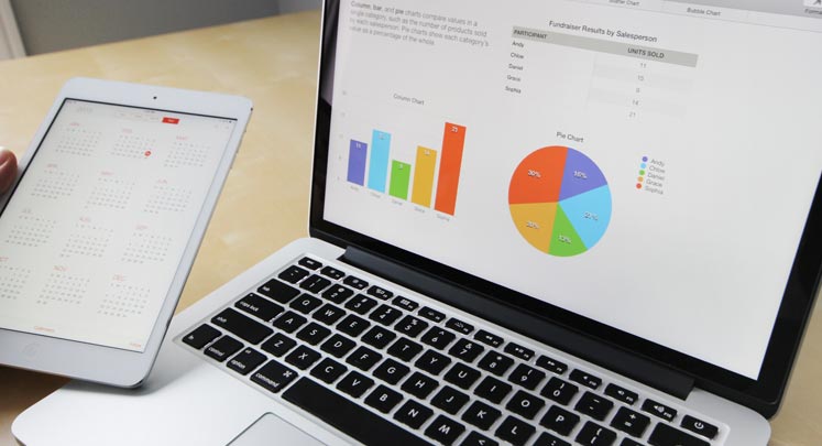 laptop and tablet view of charts and calendar